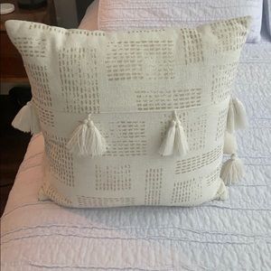 Cream colored throw pillow, with gold detailing